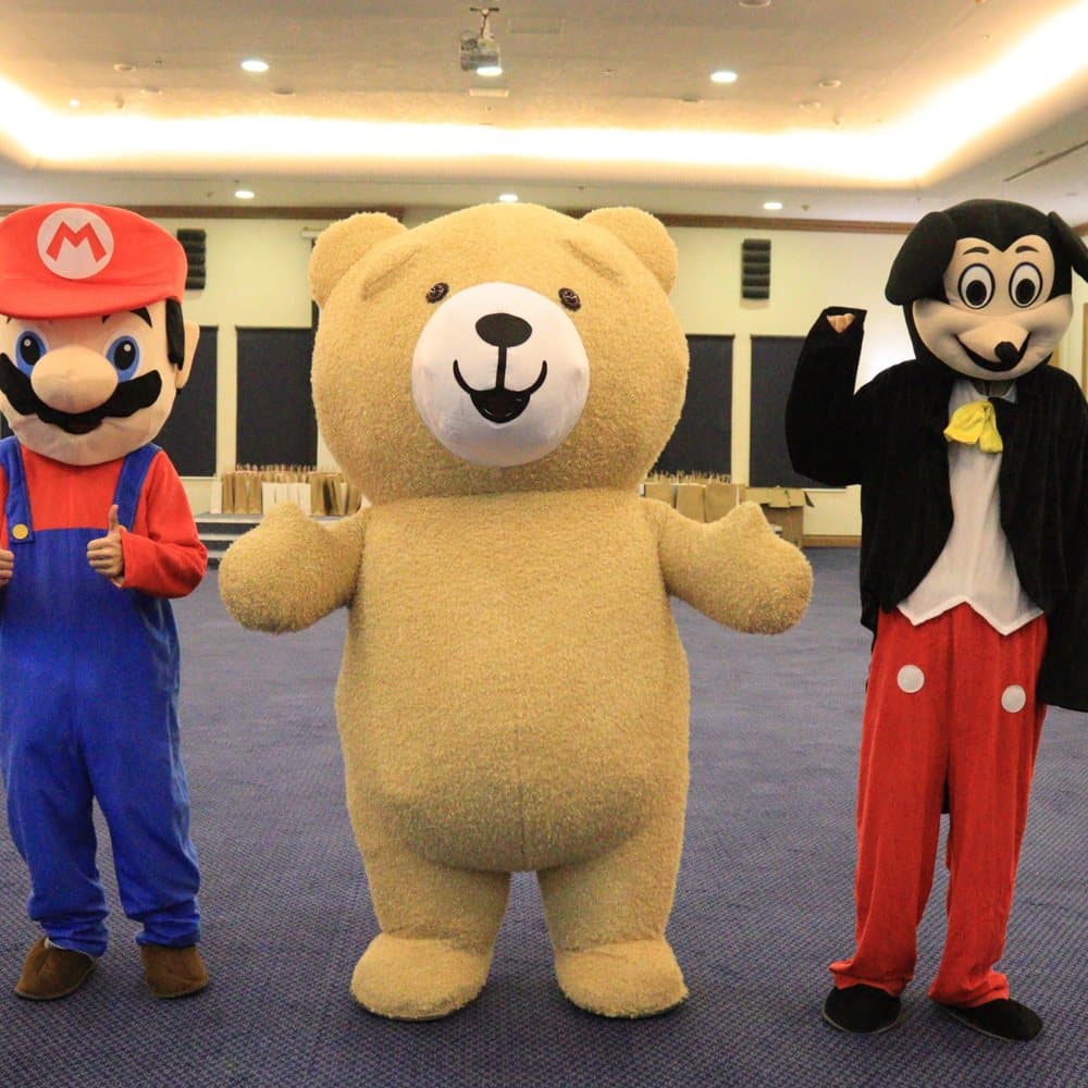 Three costumed characters entertaining the children