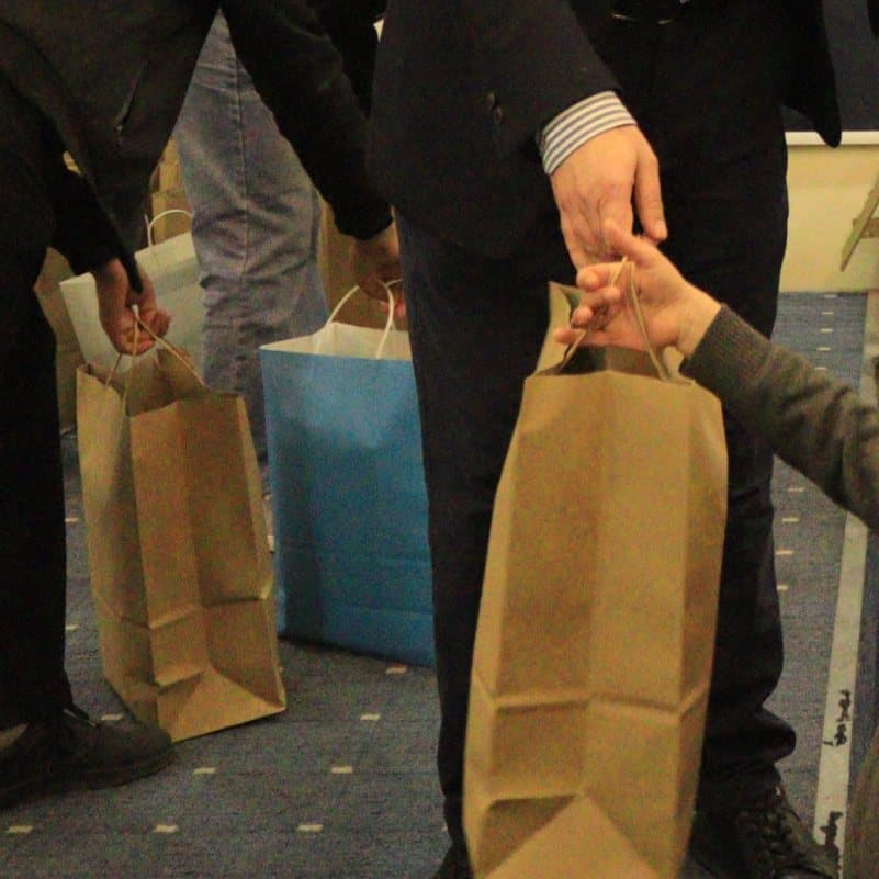 A gift bag being handed to a child