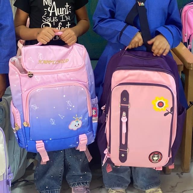 Students holding their new backpacks
